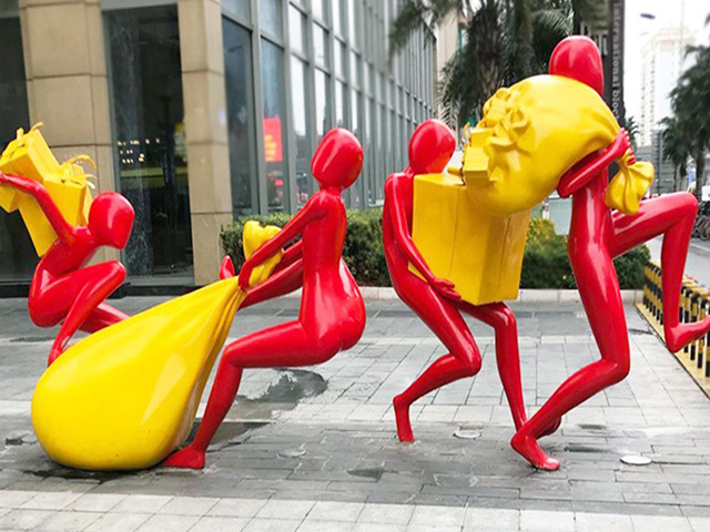 Urban Elegance sculpture in outdoor mall setting at dusk